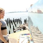 Speaker Melissa Mark-Viverito takes in a painting of the shoreline.